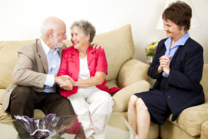 elderly couple with their caregiver