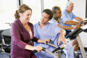 caregiver assisting elderly people in exercising